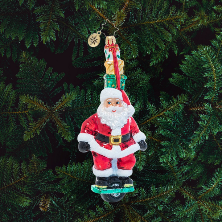 Ornament Description - One Wheelin' Santa: Proving you're never too old to learn new tricks, Santa expertly rides a single wheel while balancing a stack of gifts on his head. Is there nothing this guy can't do?