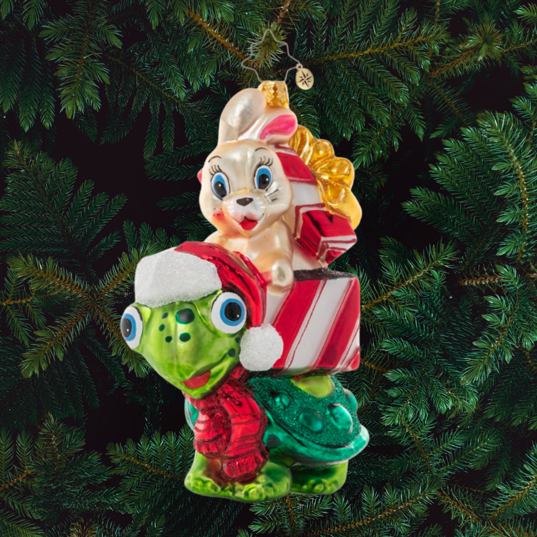Ornament Description - Race to The Finish:You know what they say…slow and steady wins the race! A tortoise and a hare team up for some Christmas time fun, racing to deliver gifts to their destinations!
