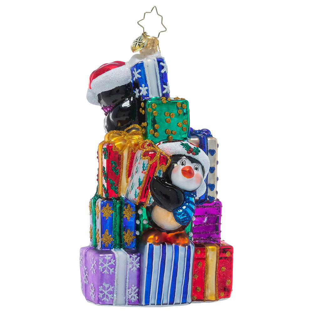 Ornaments - Description: A team of tiny penguin pals are giving the elves a day off, pitching in to help Santa stack the last of his present pile in preparation for Christmas Eve.