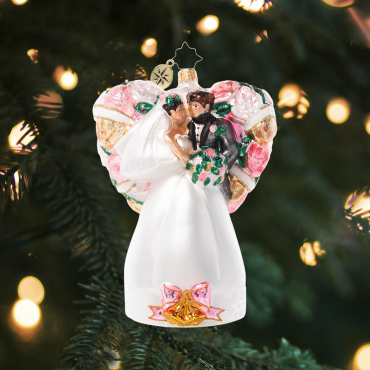Ornament Description - Love is in The Air: Just married! Honor the newlyweds in your life with this delightful heart-shaped ornament that celebrates new love.