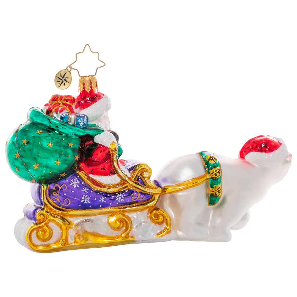 Back - Ornament Description - Polar Bear Powered: Tally ho! Santa has given his reindeer the day off, hitching his magic sleigh to a friendly polar bear for a joy ride in the snow.