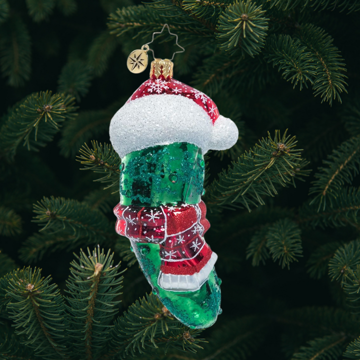 Ornament Description - Chilly Christmas Pickle: The weather outside is quite frightful, but the fire is so dill-ightful! This playful pickle is all bundled up for the cold. Find him hidden in your tree for good luck!