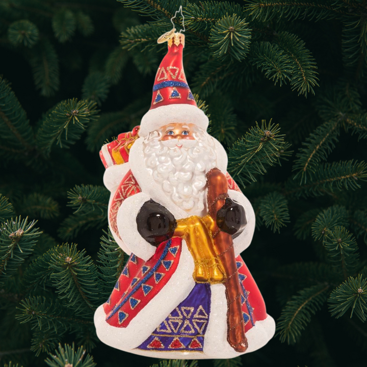 Ornament Description - Christmas Tradition Stant: Christmastime is here and this ornately dressed Santa comes bearing gifts for good boys and girls. His lush, decorated robe puts a festive spin on his typical Santa suit.