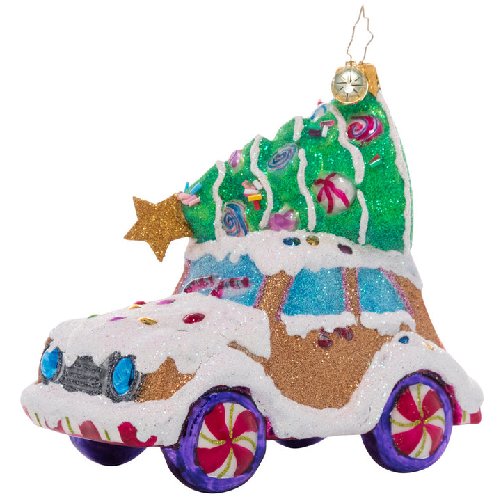 Ornament Description - Candy Tree Delivery: Over the river and through the woods…someone has driven this cookie car far and wide to find the perfect candy Christmas tree! It looks like they picked one that will be just right to brighten up their cozy gingerbread house.