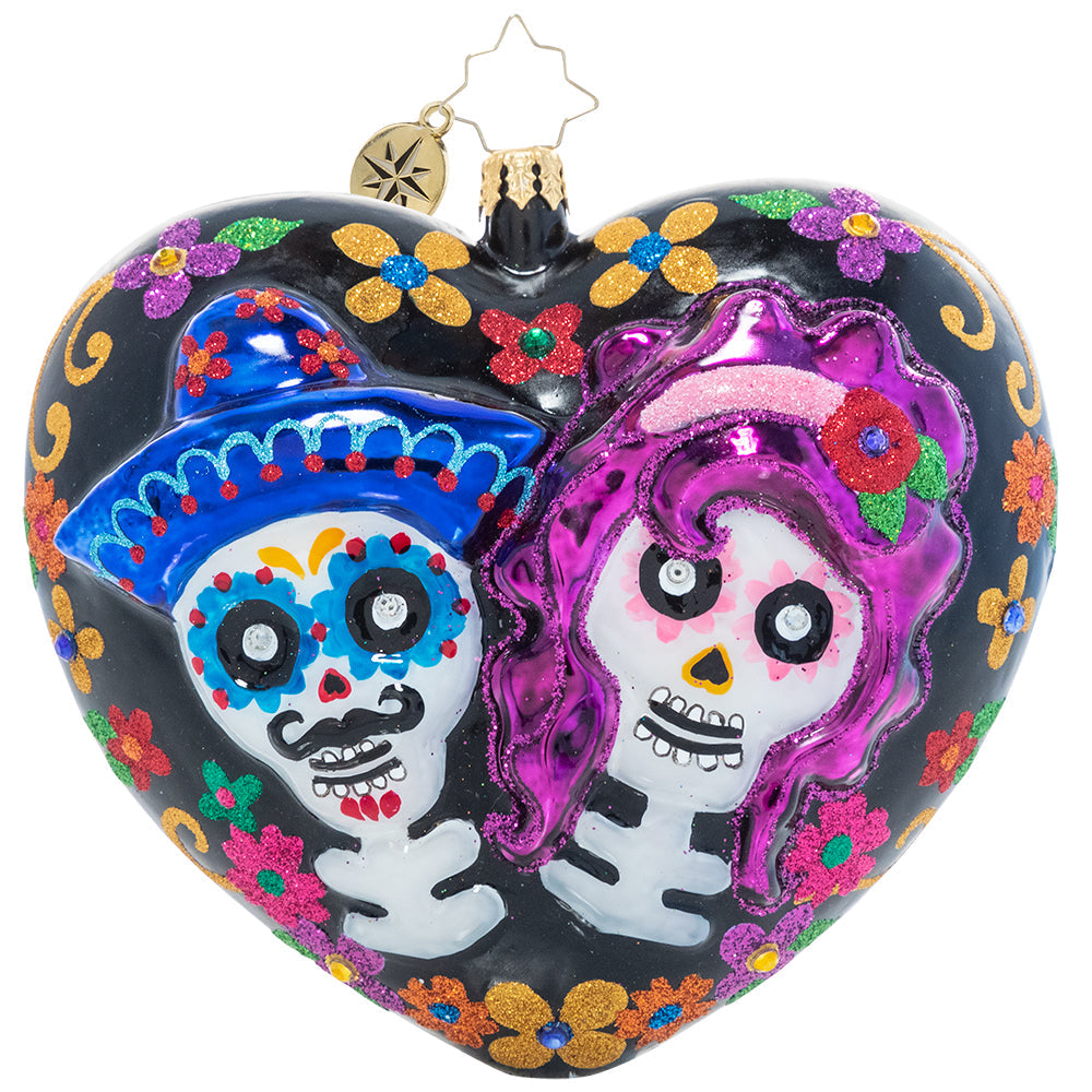 Front - Ornament Description - Sugar Skull Sweethearts: Remember those we've lost and celebrate love and life with this brightly colored heart-shaped ornament. Beautiful stylized flowers adorn one side while two sugar skull lovers wink out from the other on this Día de los Muertos-inspired ornament.