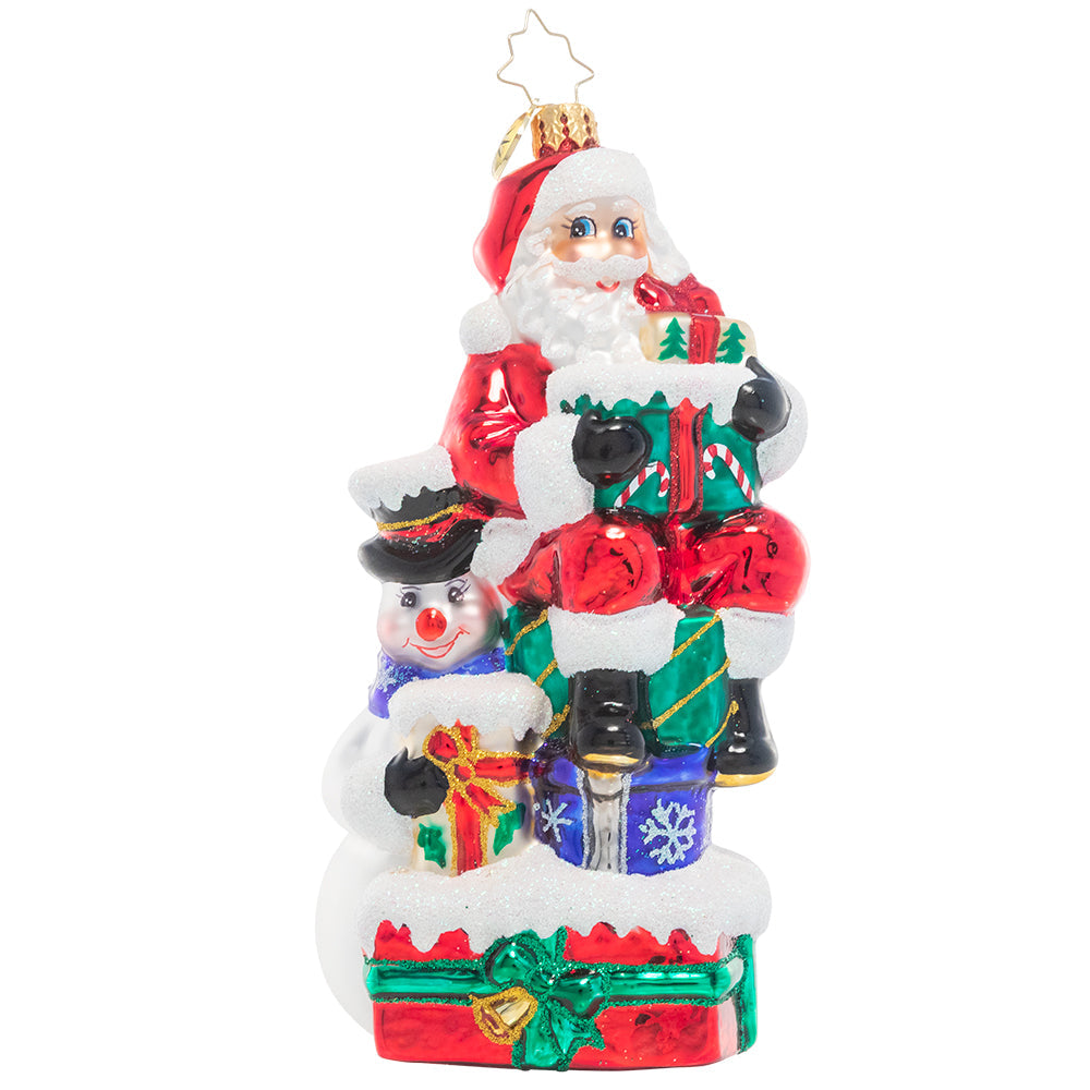 Ornament Description - A Little Help From a Friend: Santa enlists the help of his snowman friend as he prepares for his Christmas deliveries. After all, that's what friends are for!