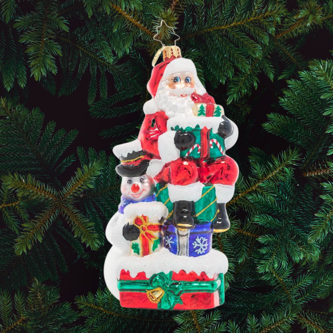 Ornament Description - A Little Help From a Friend: Santa enlists the help of his snowman friend as he prepares for his Christmas deliveries. After all, that's what friends are for!