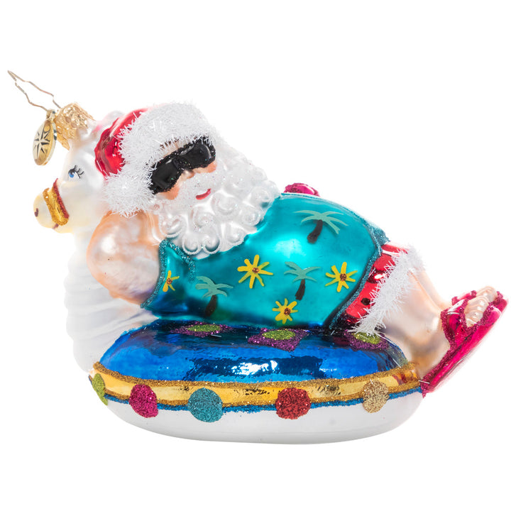 Front - Ornament Description - Ho-Ho-Holiday in the Sun: All that time in the snowy North Pole clearly has made Santa into an expert at chilling! Here he kicks back on a pool floatie for a well-deserved holiday in the sun after his busiest night of the year.
