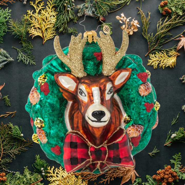 Ornament Description - Rustic Reindeer Wreath: Dasher or Dancer, Prancer or Vixen? One of Santa's trusted regular-nosed reindeers peeks through a holiday wreath in this festive ornament.