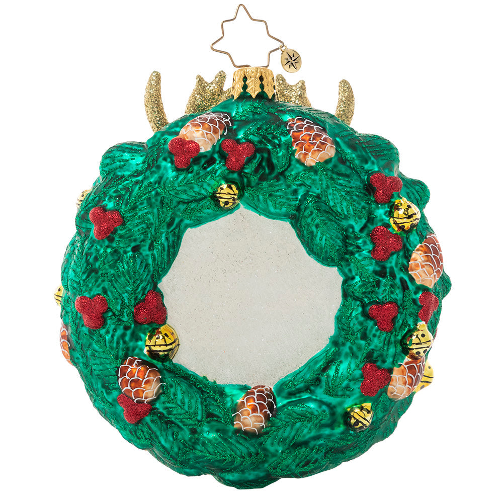Back - Ornament Description - Rustic Reindeer Wreath: Dasher or Dancer, Prancer or Vixen? One of Santa's trusted regular-nosed reindeers peeks through a holiday wreath in this festive ornament.