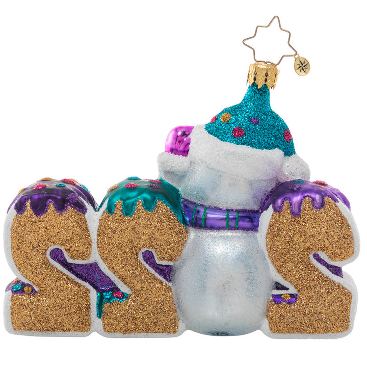 Ornaments - Description: Celebrate 2022 with this jolly ornament featuring a snowman and his candy stash. Here's hoping the year is a tasty treat for us all!