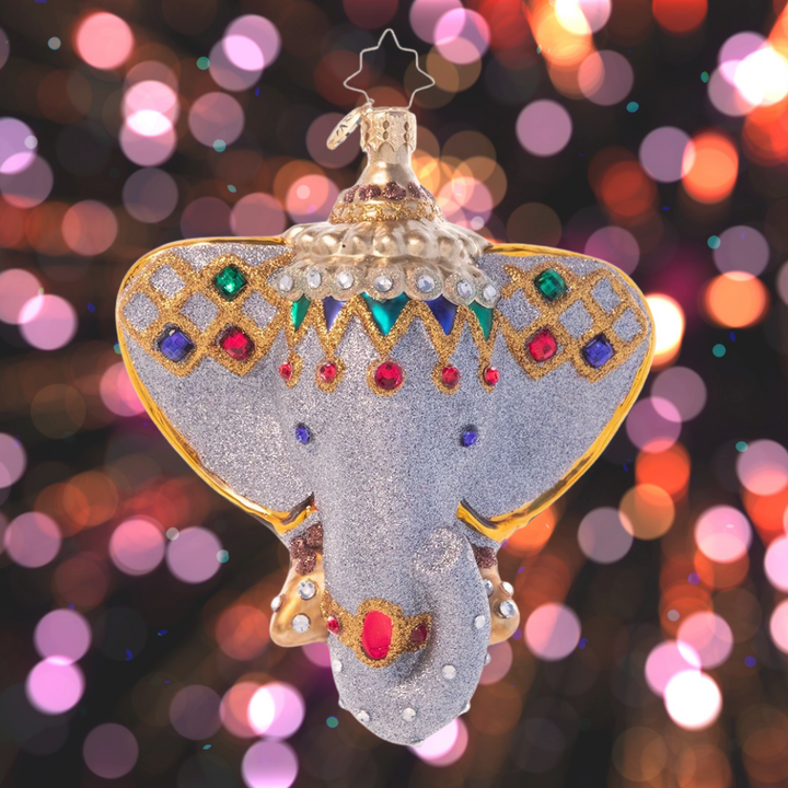 Ornament Description - Opulent Elephant: Beckon the far east home with this stunning Indian elephant ornament. Adorned with bold jewels and rich gold, this elegant icon is said to bestow wisdom and good fortune to the home of all who possess it.
