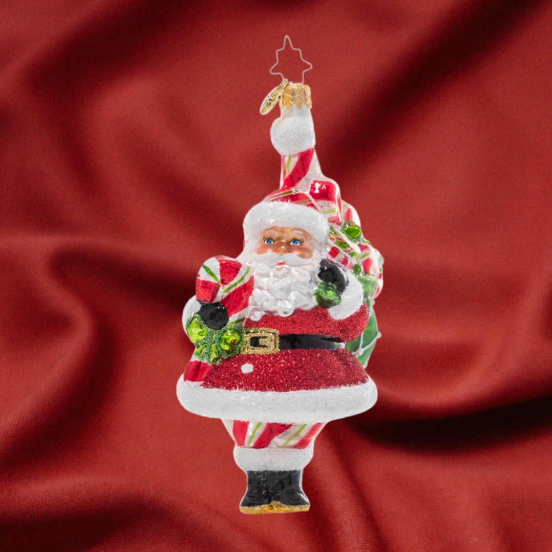 Ornament Description - Peppy Mint Santa: Santa's got a whole lot of pep(permint!) in his step these days. Outfitted in head to toe candy-cane red, white, and green he's dressed the part to hand out delicious Christmas candies to every good girl and boy! 