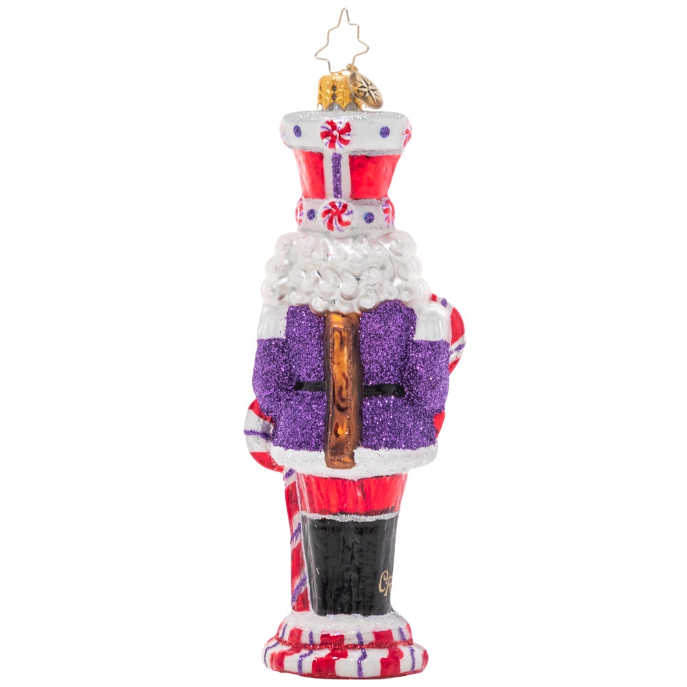 Back - Ornament Description - Candy Cane Cracker: How sweet it is! This peppy candy-cane themed nutcracker is ready to celebrate the holiday season in swirling red and white.