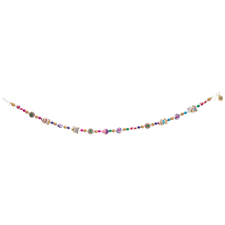 Garland/Trim Description - Sweet Treats Garland: Cupcakes, candy, and cookies, oh my! Make your holiday that much sweeter with this adorable garland featuring all sorts of tasty Christmas treats. This photo shows how the garland might hang. 