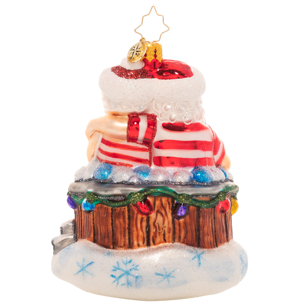 Back - Ornament Description - Holiday Hot Tub: There's nothing like a bubbling hot tub after a long day of baking and toy making! Mr. and Mrs. Claus take a well-deserved break to rest and relax.