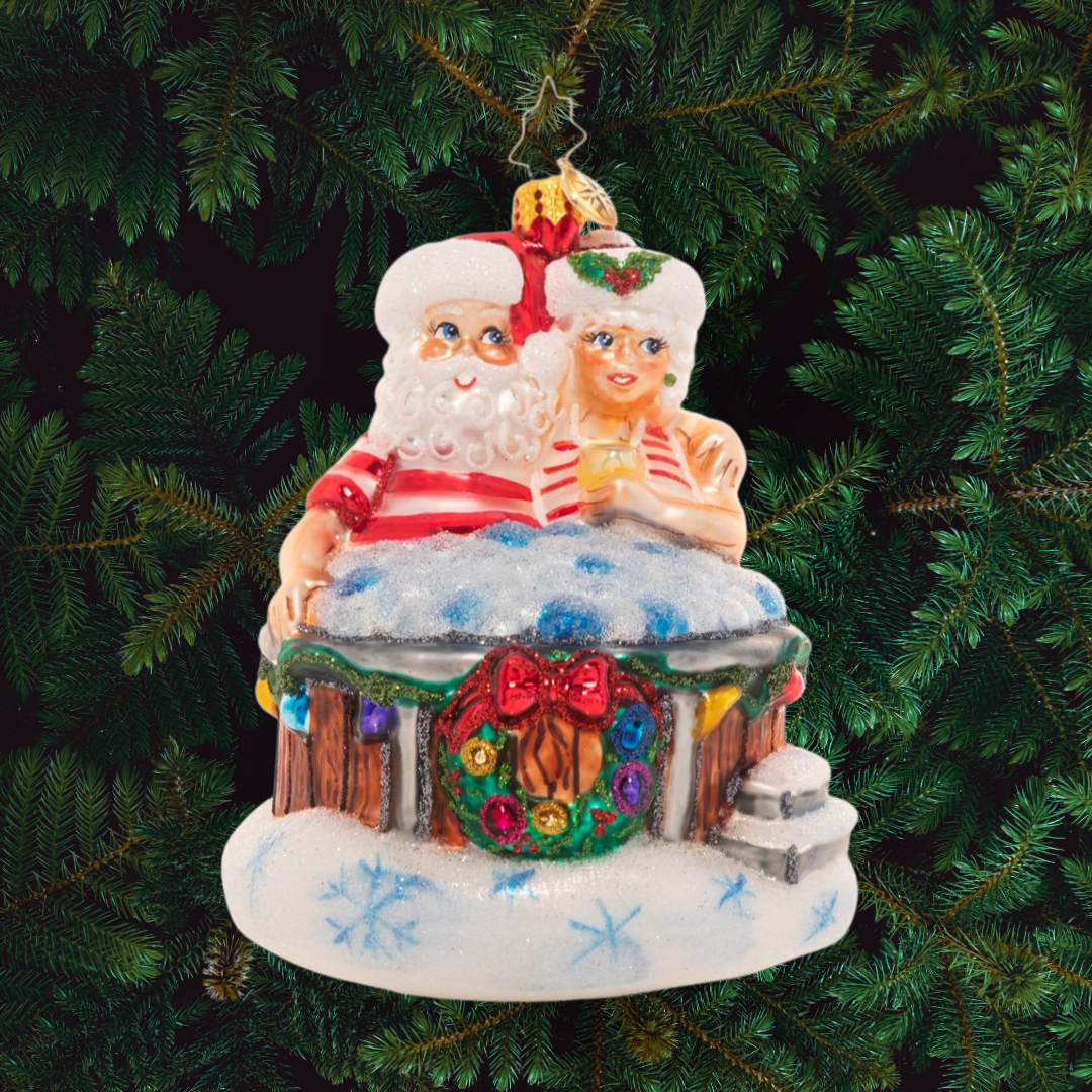Ornament Description - Holiday Hot Tub: There's nothing like a bubbling hot tub after a long day of baking and toy making! Mr. and Mrs. Claus take a well-deserved break to rest and relax.