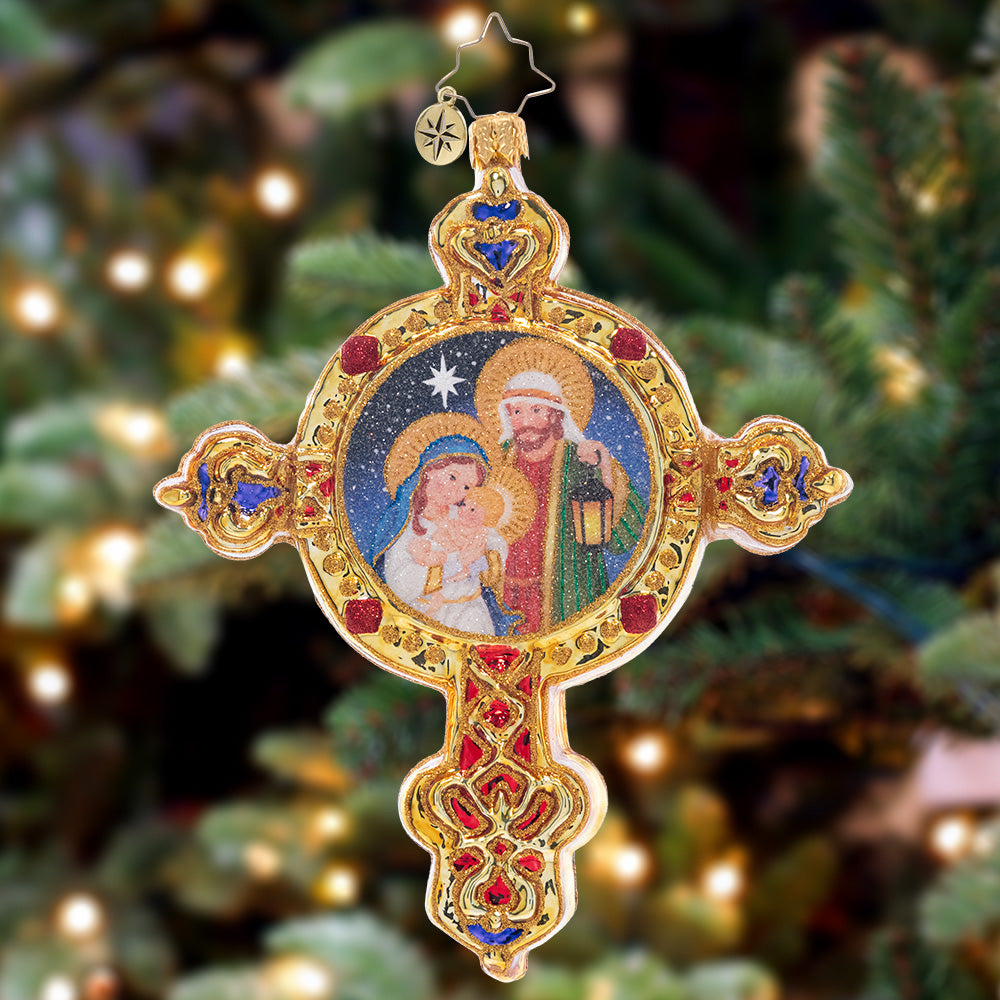 Ornament Description - Radiant Guiding Light: This gleaming golden cross features the beautiful scene of baby Jesus, Mary, and Joseph – a piece that celebrates the beauty of Christmas.