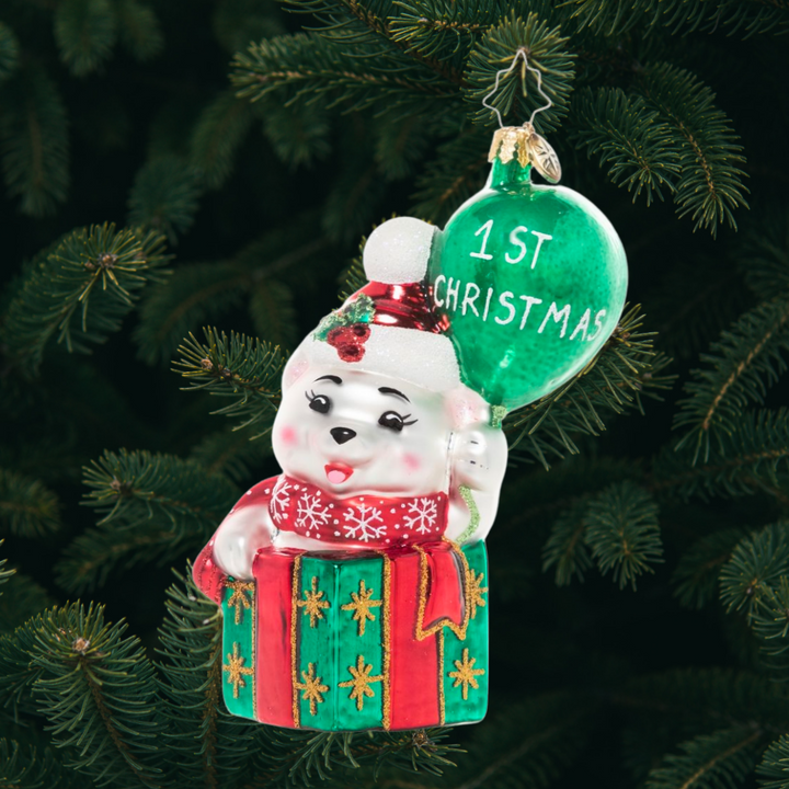Ornament Description - Baby Bear's 1st Christmas: This baby bear is peeking out of a gift box, ready to share a cheerful message – Happy 1st Christmas to the new arrival in your life!