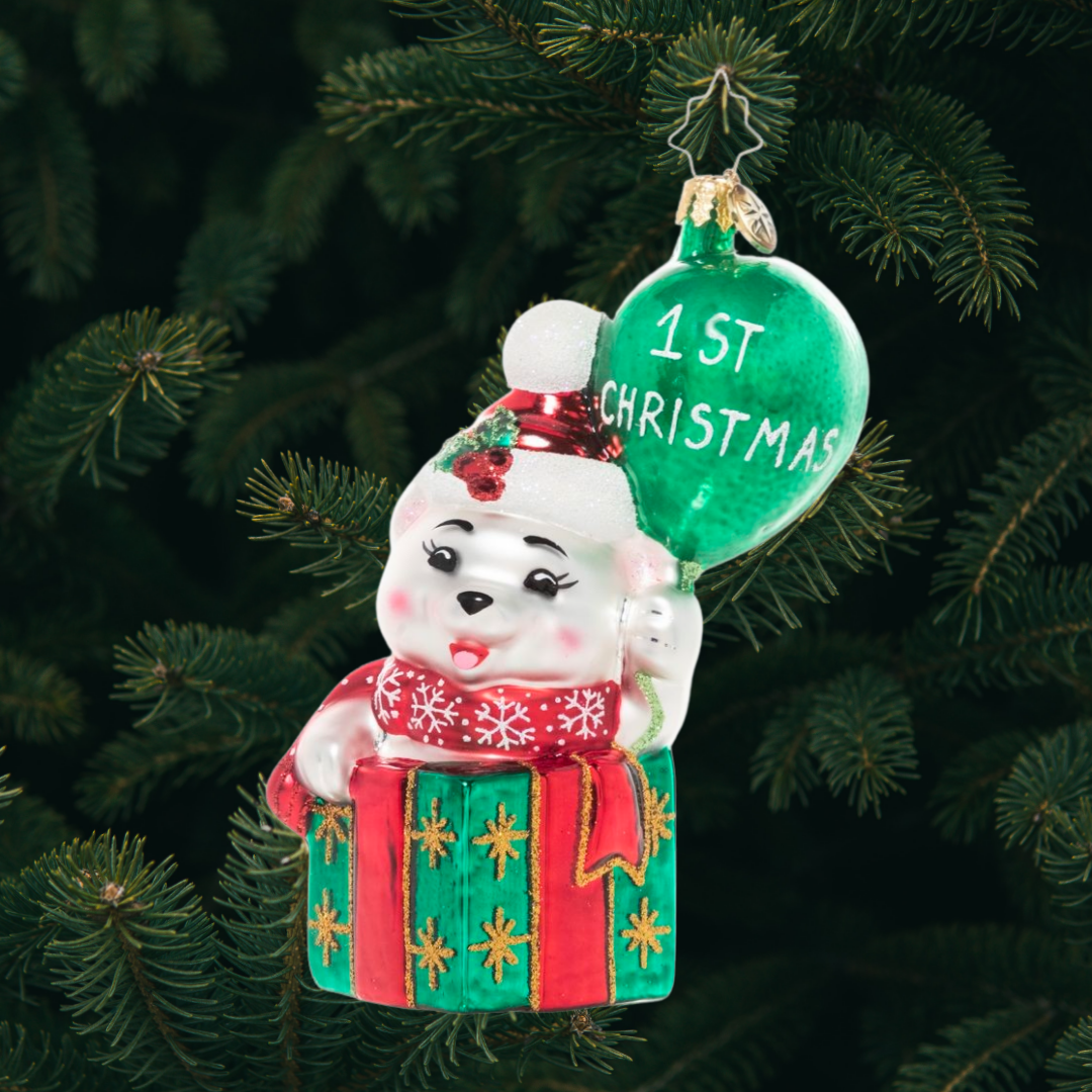 Ornament Description - Baby Bear's 1st Christmas: This baby bear is peeking out of a gift box, ready to share a cheerful message – Happy 1st Christmas to the new arrival in your life!