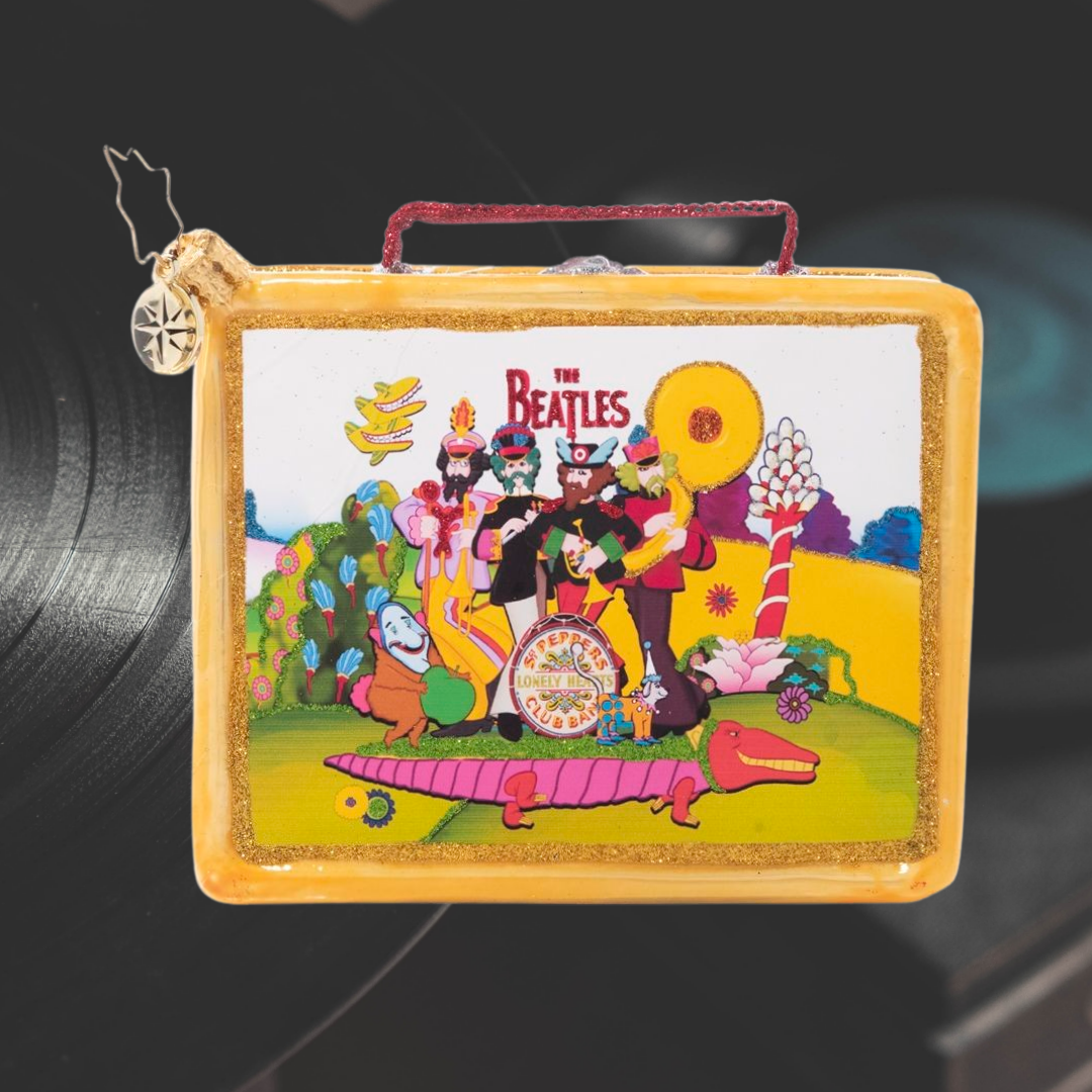 Ornament Description - Let's Do Lunch: Fashioned after the classic tin lunch boxes of yesteryear and featuring colorful scenes from Yellow Submarine, this playful piece packs a powerful punch of nostalgia. Is it lunchtime yet?