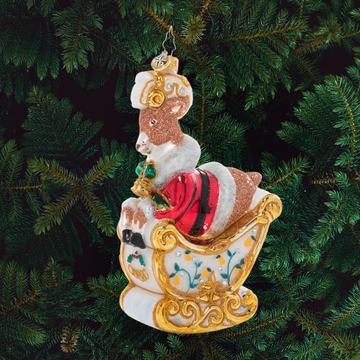 Ornament Description - Gleaming Golden Rings: On the fifth day of Christmas, my true love gave to me…a cheeky reindeer driving Santa's sleigh! The gilded sleigh, adorned with floral accents and a crest of five golden rings, flies through the air with Dasher at the helm. This and eleven additional fun pieces are available as part of our Ornament of the Month collection!