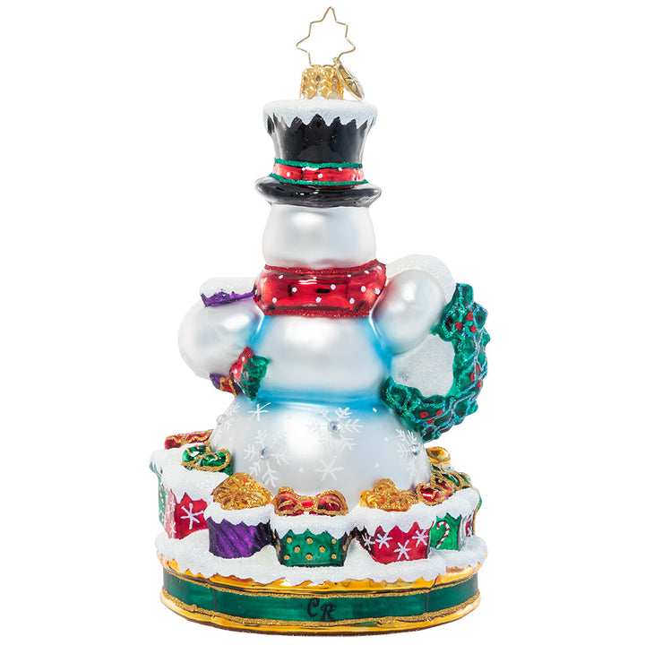 Ornaments - Description: Celebrate 2022 with a smile, just like the one on this happy snowman's face. Surrounded by gifts ready to give, he's really feeling the spirit of the season!