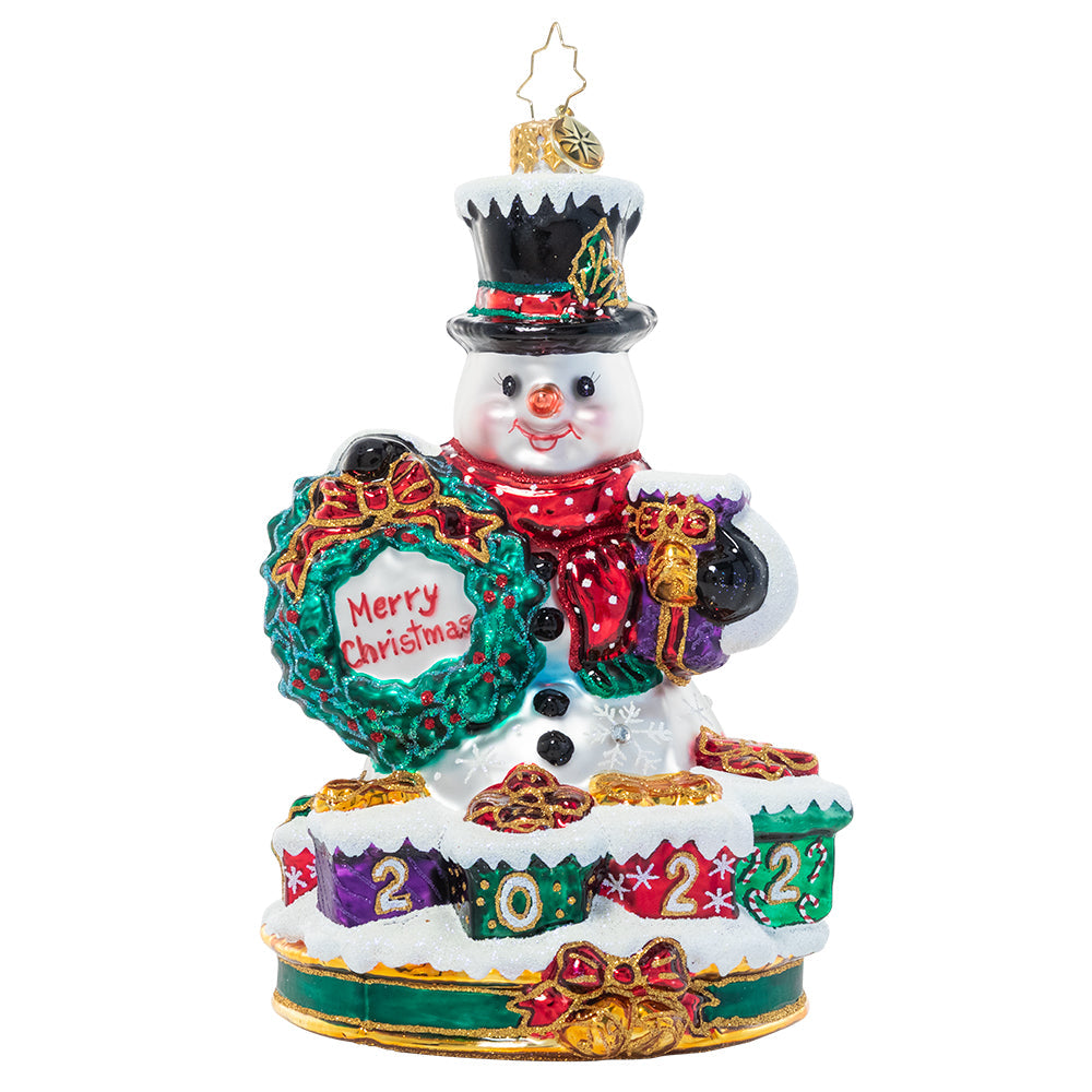 Ornaments - Description: Celebrate 2022 with a smile, just like the one on this happy snowman's face. Surrounded by gifts ready to give, he's really feeling the spirit of the season!