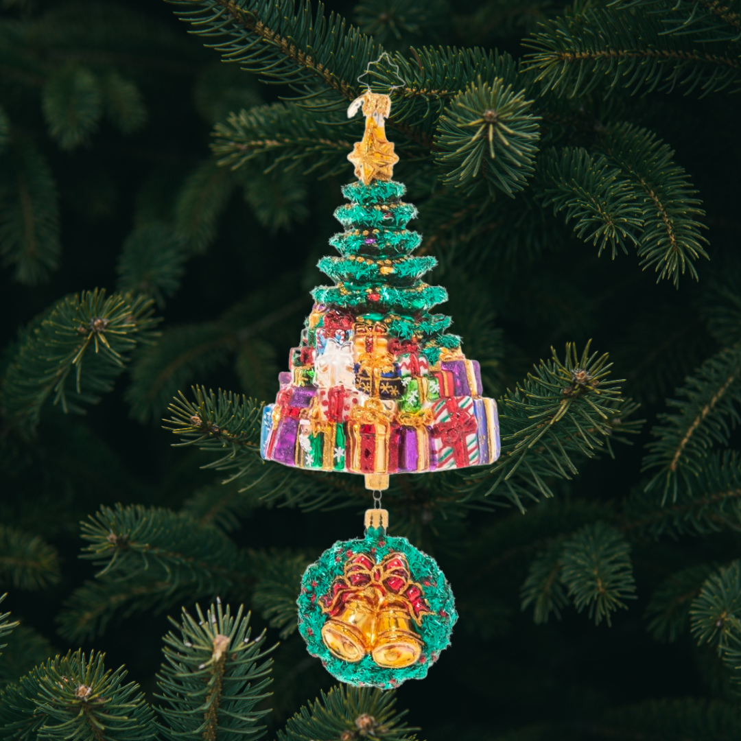 Ornament Description - Christmas Splendor Tree: It's beginning to look a lot like Christmas! A glitzy Christmas tree peeks out above a giant pile of presents, with a musical wreath poised beneath.