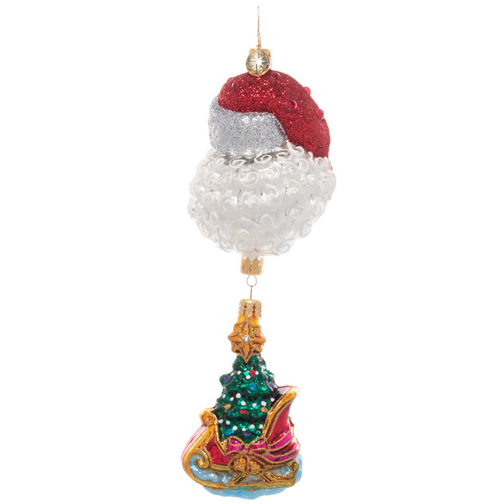 Back - Ornament Description - Santa's Magic Sleigh: If you're looking for the perfect piece to add a unique twist to traditional Christmas imagery, this is the one! An ornate sleigh ornament, carrying a fully trimmed Christmas tree dangles from a larger ornament of Santa's smiling face.