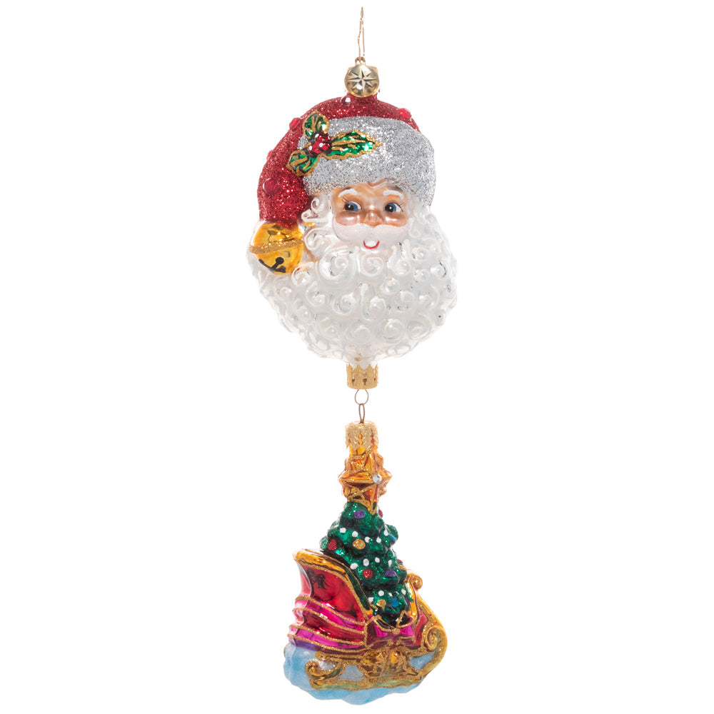 Front - Ornament Description - Santa's Magic Sleigh: If you're looking for the perfect piece to add a unique twist to traditional Christmas imagery, this is the one! An ornate sleigh ornament, carrying a fully trimmed Christmas tree dangles from a larger ornament of Santa's smiling face.