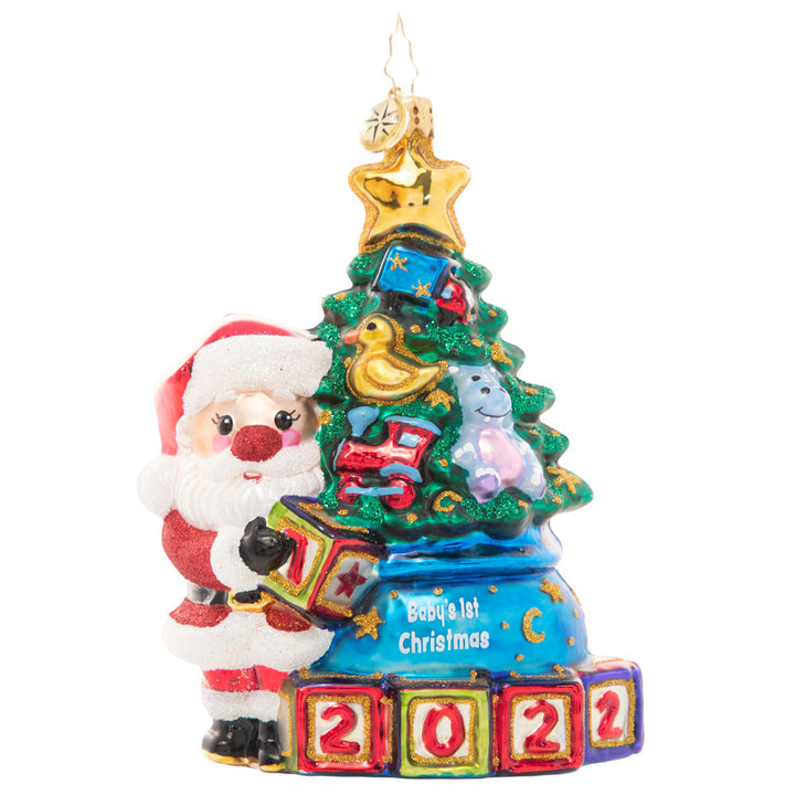 Front - Ornament Description - Extra Special Delivery: This adorable Santa has taken extra special care of the latest addition to his nice list – a new baby in the family! Celebrate their first Christmas with this darling ornament featuring a tiny tree decorated with special treasures to delight any little one.