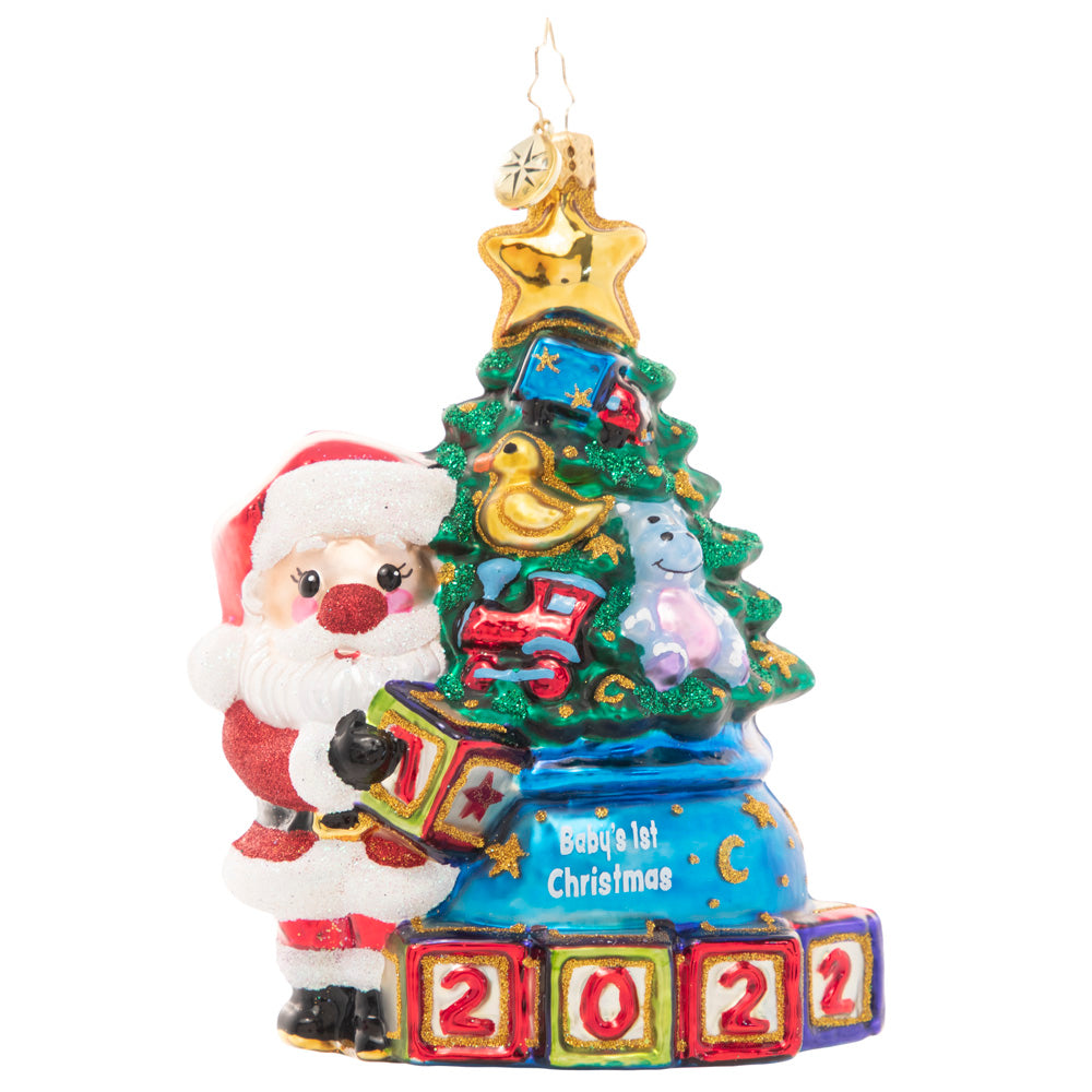 Front - Ornament Description - Extra Special Delivery: This adorable Santa has taken extra special care of the latest addition to his nice list – a new baby in the family! Celebrate their first Christmas with this darling ornament featuring a tiny tree decorated with special treasures to delight any little one.