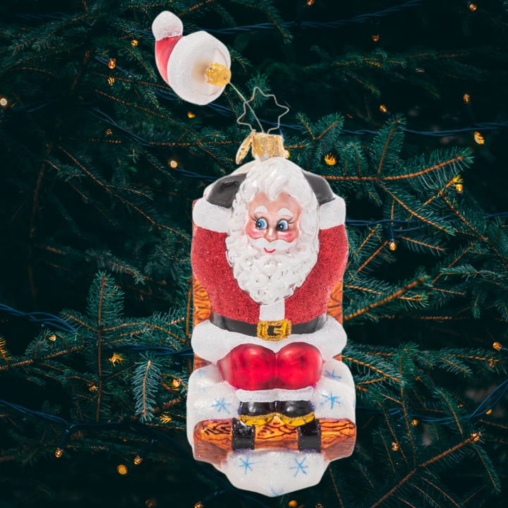 Ornament Description - Hats Off Sledding Santa: Hold on to your hat! This whimsical Santa has been speeding down the slopes on his sled so fast that his hat is getting left behind!