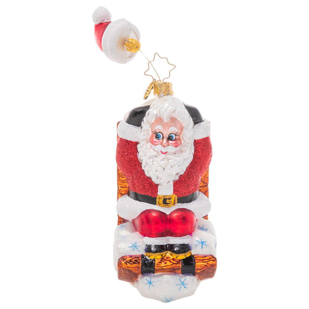 Front - Ornament Description - Hats Off Sledding Santa: Hold on to your hat! This whimsical Santa has been speeding down the slopes on his sled so fast that his hat is getting left behind!