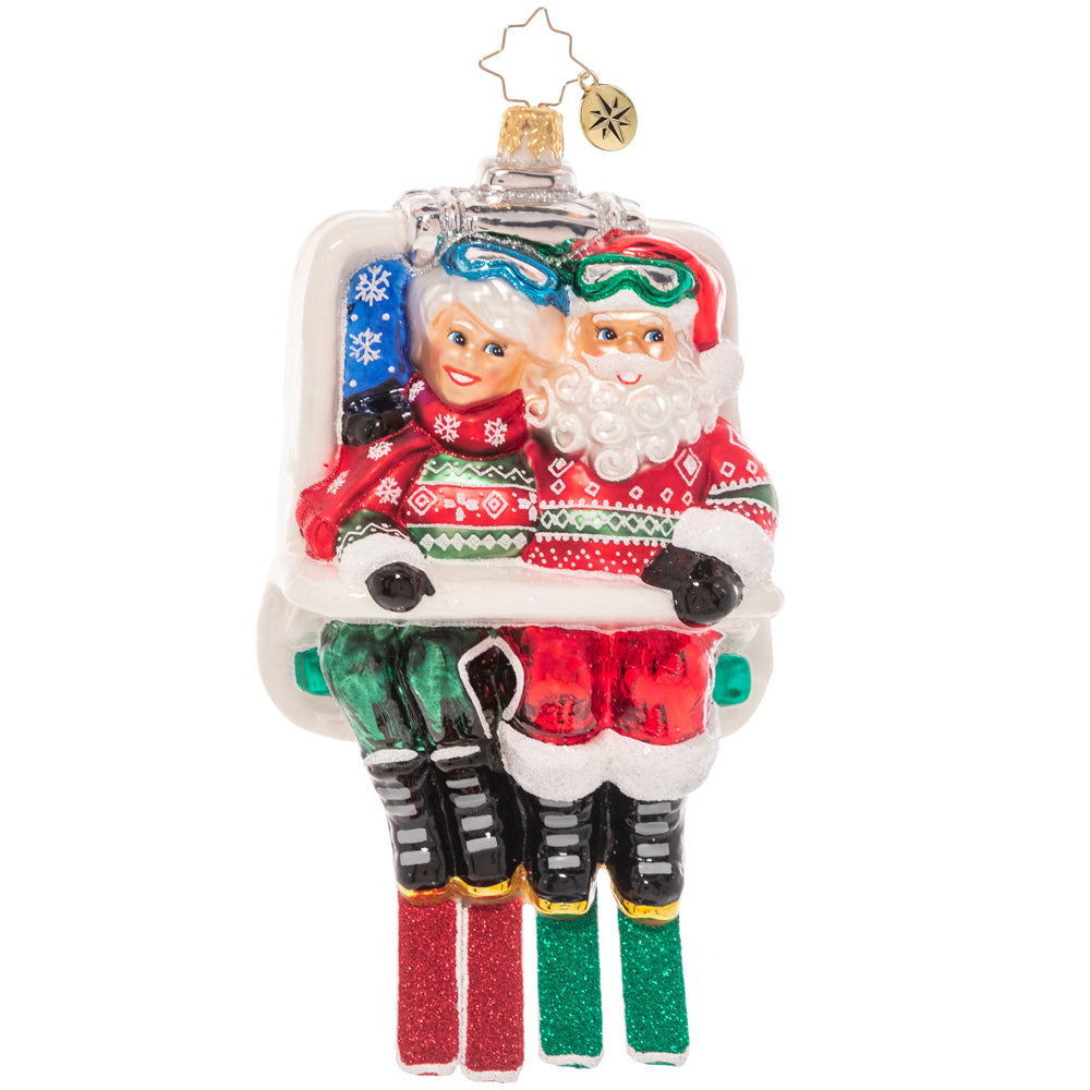 Ornaments - Description: Santa and Mrs. Claus are geared up and hitting the slopes, snuggling together on the ski lift on their way up the mountain. Celebrating Christmas cheer, longtime love, and their favorite snow sport, this ornament is the perfect gift for any ski couple in your life!