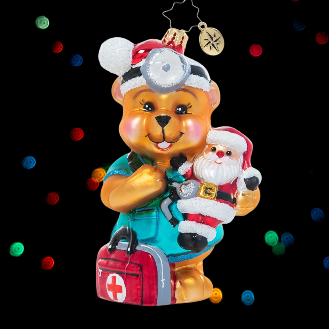 Ornament Description - The Doctor is In: Dr. Teddy is ready to see (and snuggle!) some patients! He believes that love is the best medicine and wants to share encouragement and cheer with the sick children who need him most. A percentage of the sales from this ornament will benefit Pediatric Cancer charities.