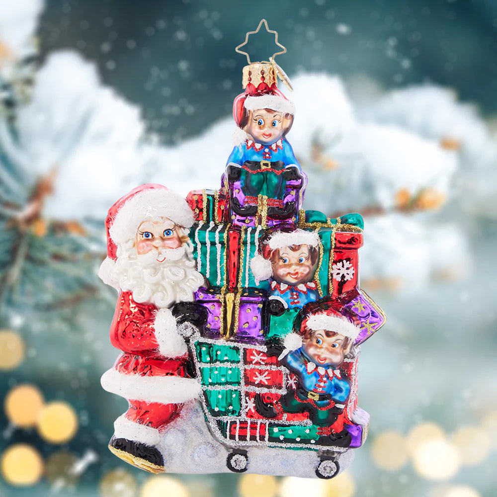 Ornament Description - Savvy Shopper Santa: Santa says it's time to shop 'til you drop! With the assistance of his elf helpers, he's picking up the season's best tidings to deliver this Christmas.
