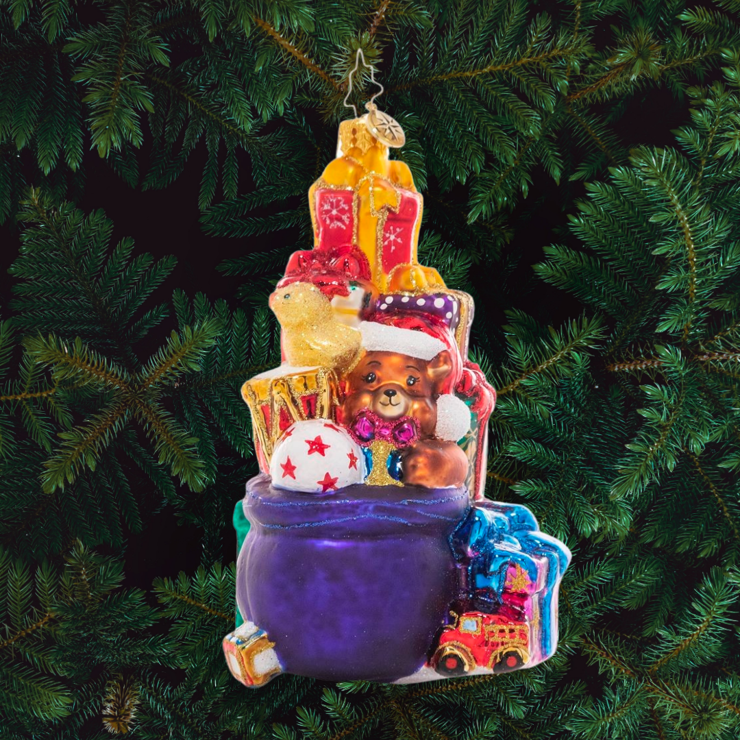 Ornament Description - Stacked Up Surprises: Someone has been extra good this year! This towering pile of colorful presents is full of surprises for lucky little girls and boys.