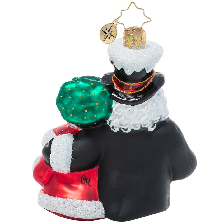 Back - Ornament Description - A Dazzling Duet: Mr. & Mrs. Claus team up for one of their favorite holiday traditions – Christmas caroling! They warm hearts and spread holiday spirit all over town with their music.