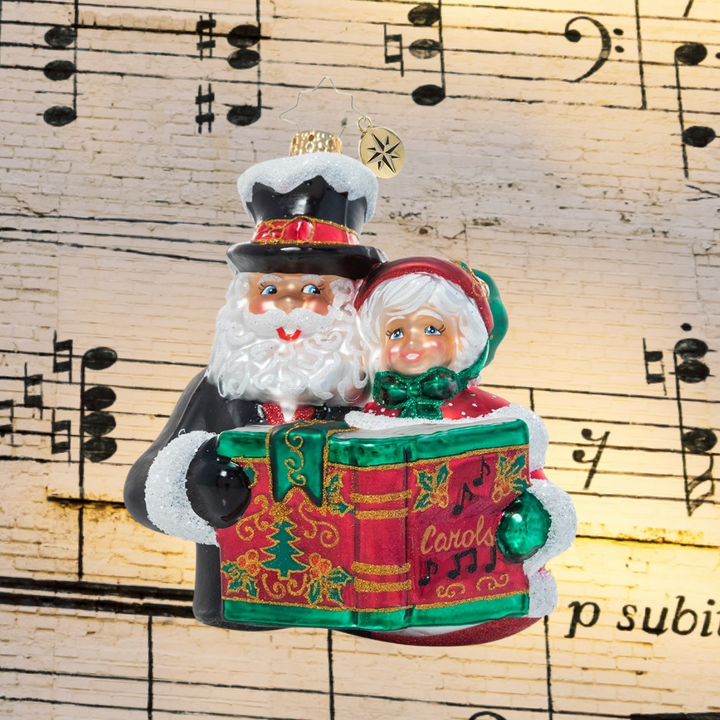 Ornament Description - A Dazzling Duet: Mr. & Mrs. Claus team up for one of their favorite holiday traditions – Christmas caroling! They warm hearts and spread holiday spirit all over town with their music.