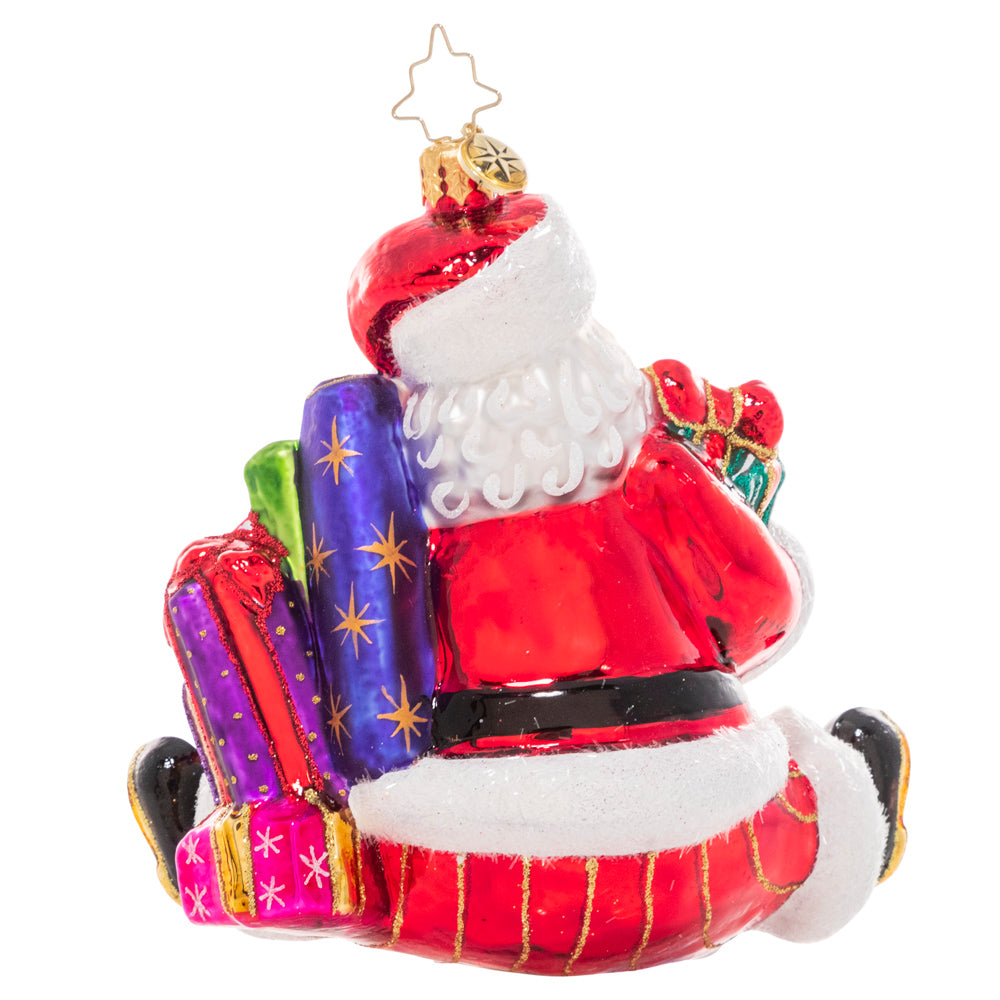 Back - Ornament Description - That's a Wrap Santa!: No surprise that the Christmas king is also a major wrap star! Santa's ready to give with his arms loaded with lovingly-wrapped presents in every size and shape.