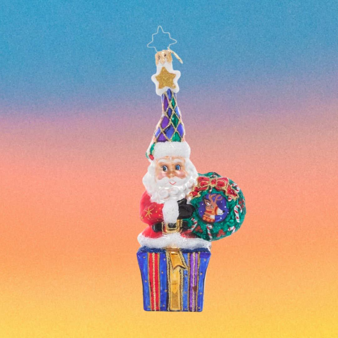 Ornament Description - Marry & Bright Santa: Outfitted in cheery Christmas colors, this Santa is dressed to celebrate the season. He's holding hope for a wonderful holiday and a peaceful new year for us all!
