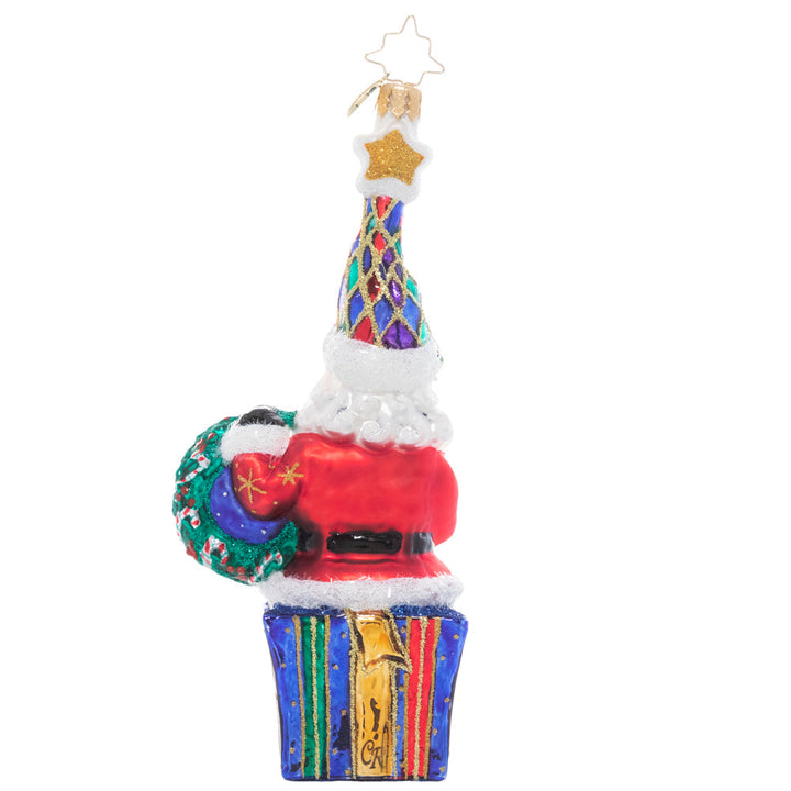 Back - Ornament Description - Marry & Bright Santa: Outfitted in cheery Christmas colors, this Santa is dressed to celebrate the season. He's holding hope for a wonderful holiday and a peaceful new year for us all!