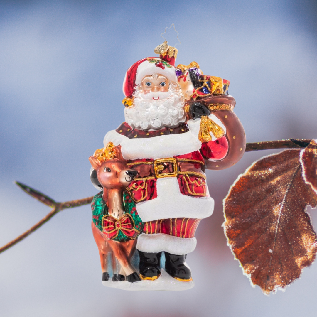 Ornament Description - A Woodland Walk Santa: Walkin' in a Winter Wonderland! Accompanied by an adorable woodland companion, Santa takes a snowy stroll through the tranquil North Pole forests on his way to deliver gifts.