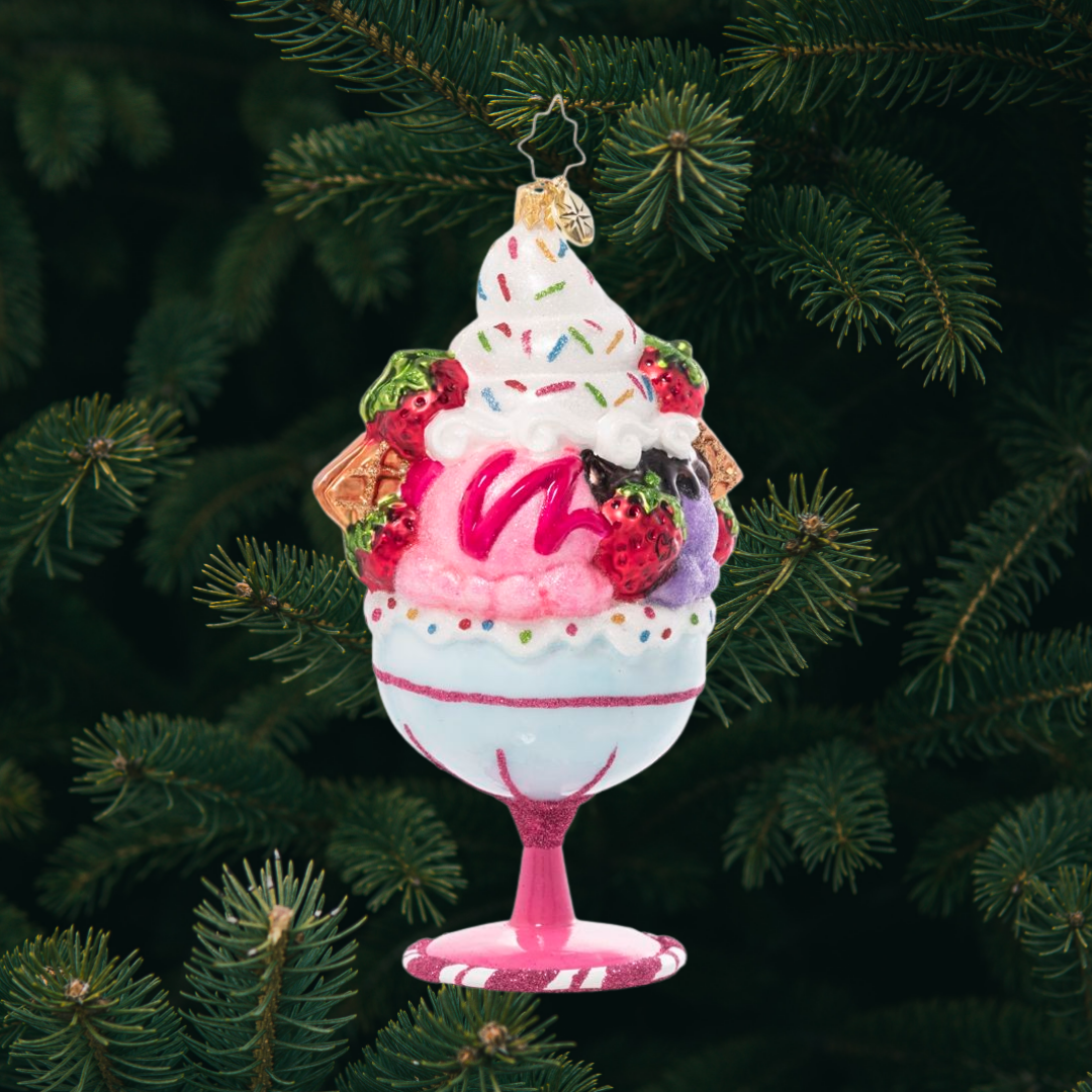 Ornament Description - Cherry on Top: Now that's what I call a sundae! Generous scoops of ice cream, dollops of whip cream, waffle cone pieces, fresh fruits, sweet syrups and loads of sprinkles fill a candy-colored goblet to create a treat that sweet dreams are made of.