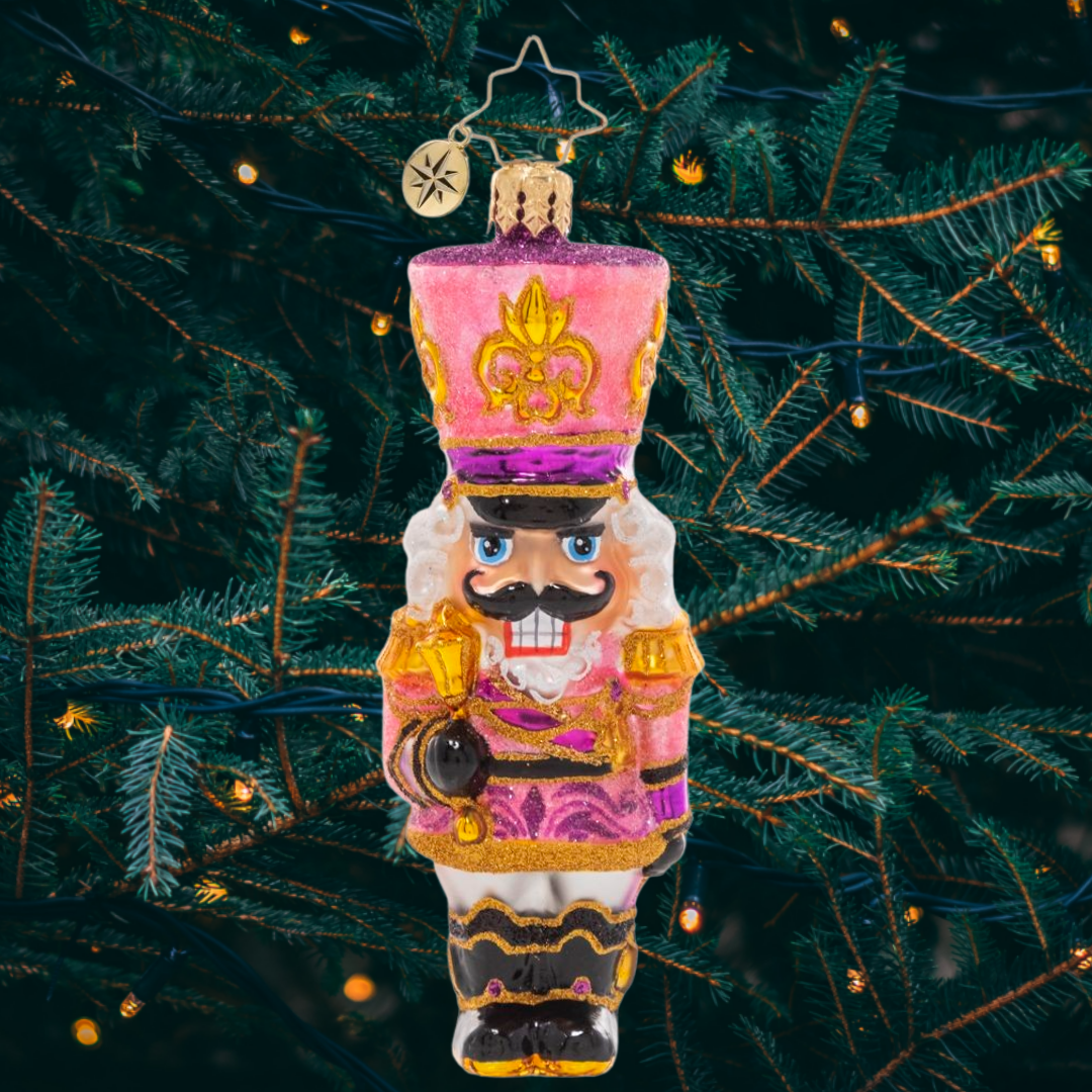 Ornament Description - Flushed With Pink - This jaunty pink sparkly nutcracker is ready to add some pizazz to the tree this year. Let's get cracking!