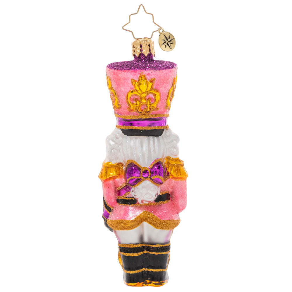 Back - Ornament Description - Flushed With Pink - This jaunty pink sparkly nutcracker is ready to add some pizazz to the tree this year. Let's get cracking!