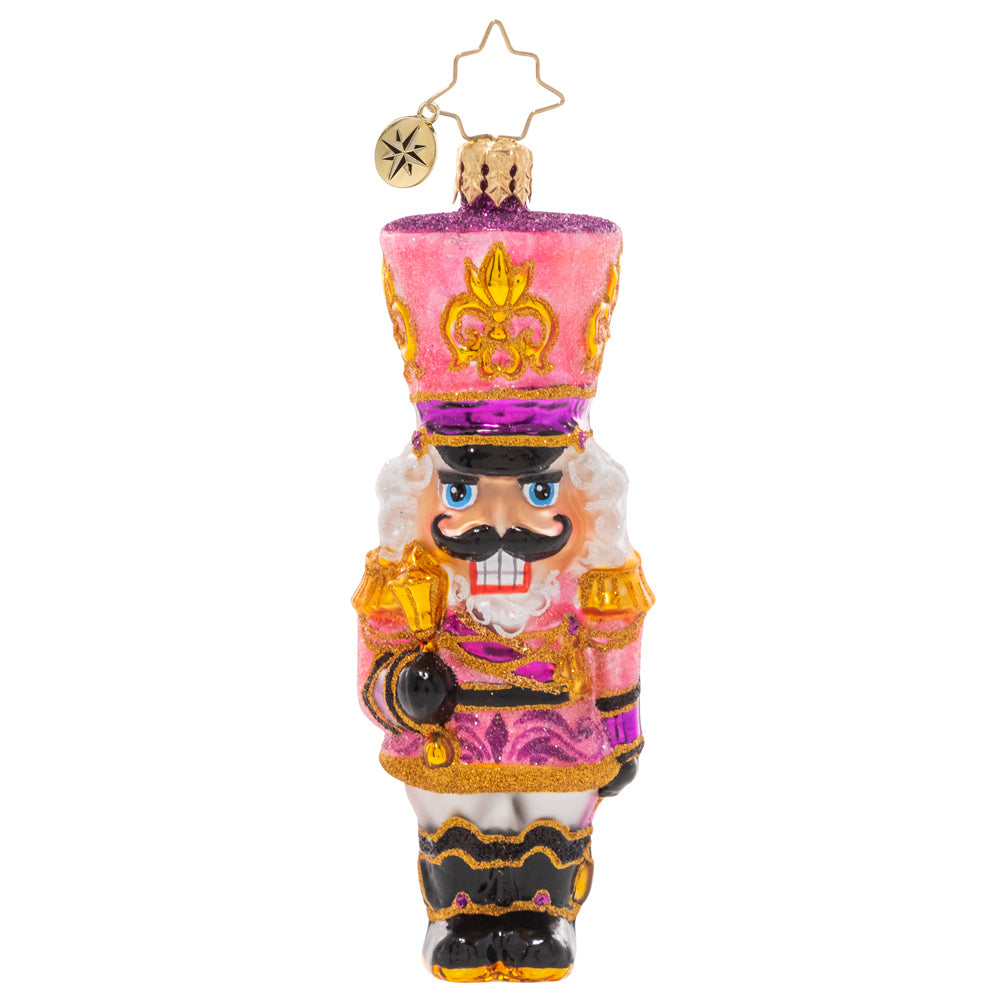 Front - Ornament Description - Flushed With Pink - This jaunty pink sparkly nutcracker is ready to add some pizazz to the tree this year. Let's get cracking!