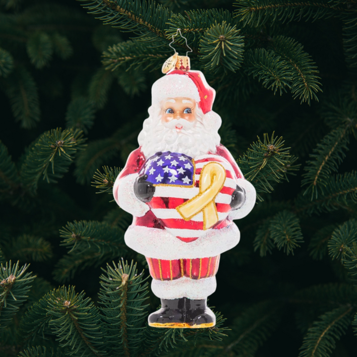 Ornament Description - Thank A Vet: Santa holds a star-spangled heart and with a yellow remembrance ribbon to show his heartfelt gratitude and respect for our brave veterans. Have you thanked a vet today? A percentage of the sales from this ornament will benefit Veteran’s charities.